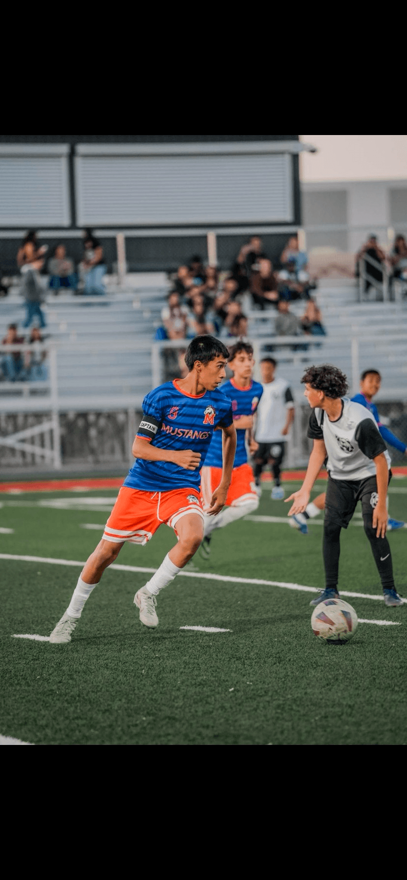 Real State Soccer Academy player, team captain, controlling the ball during a match